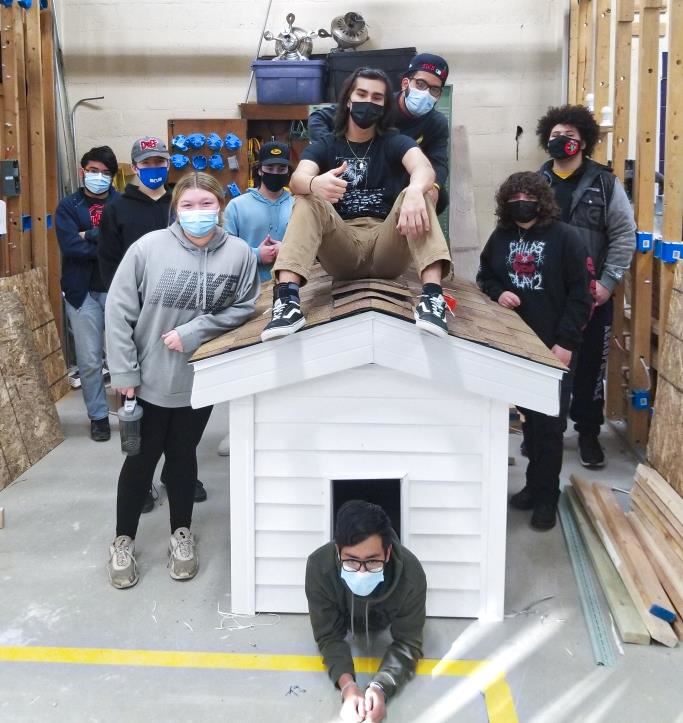 Tech Ed students posing with their constructed dog house